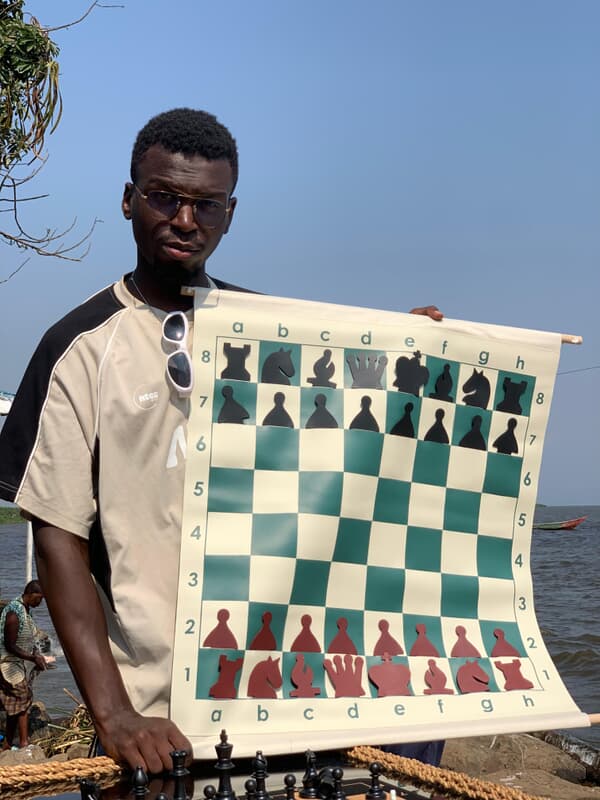 Hikaru coach holding a demonstration chess board outdoors