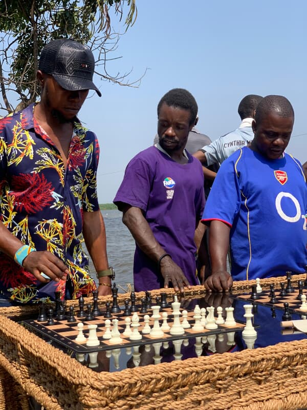Coach with chess set by the water