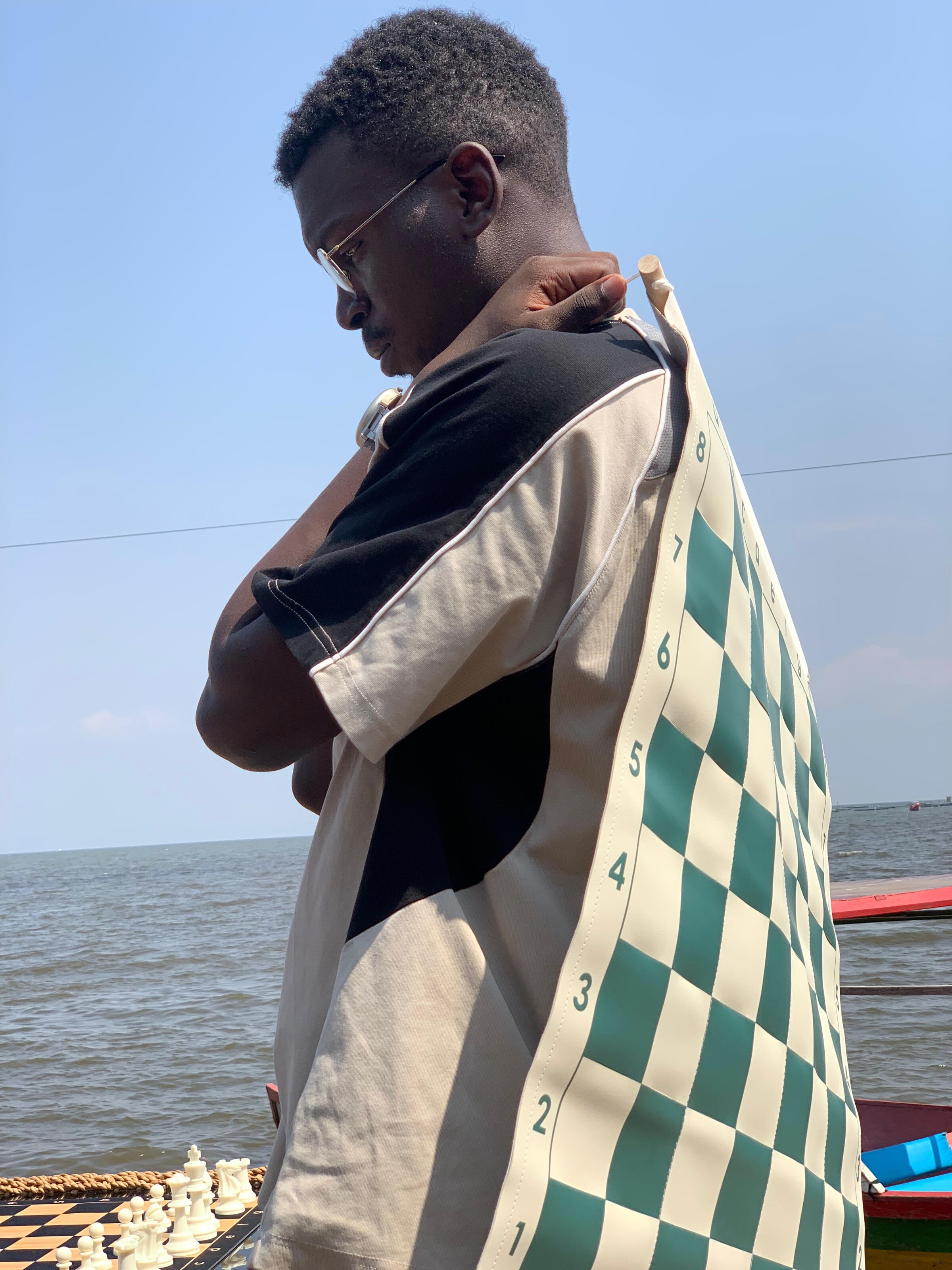 Coach with roll-up chess board by the water