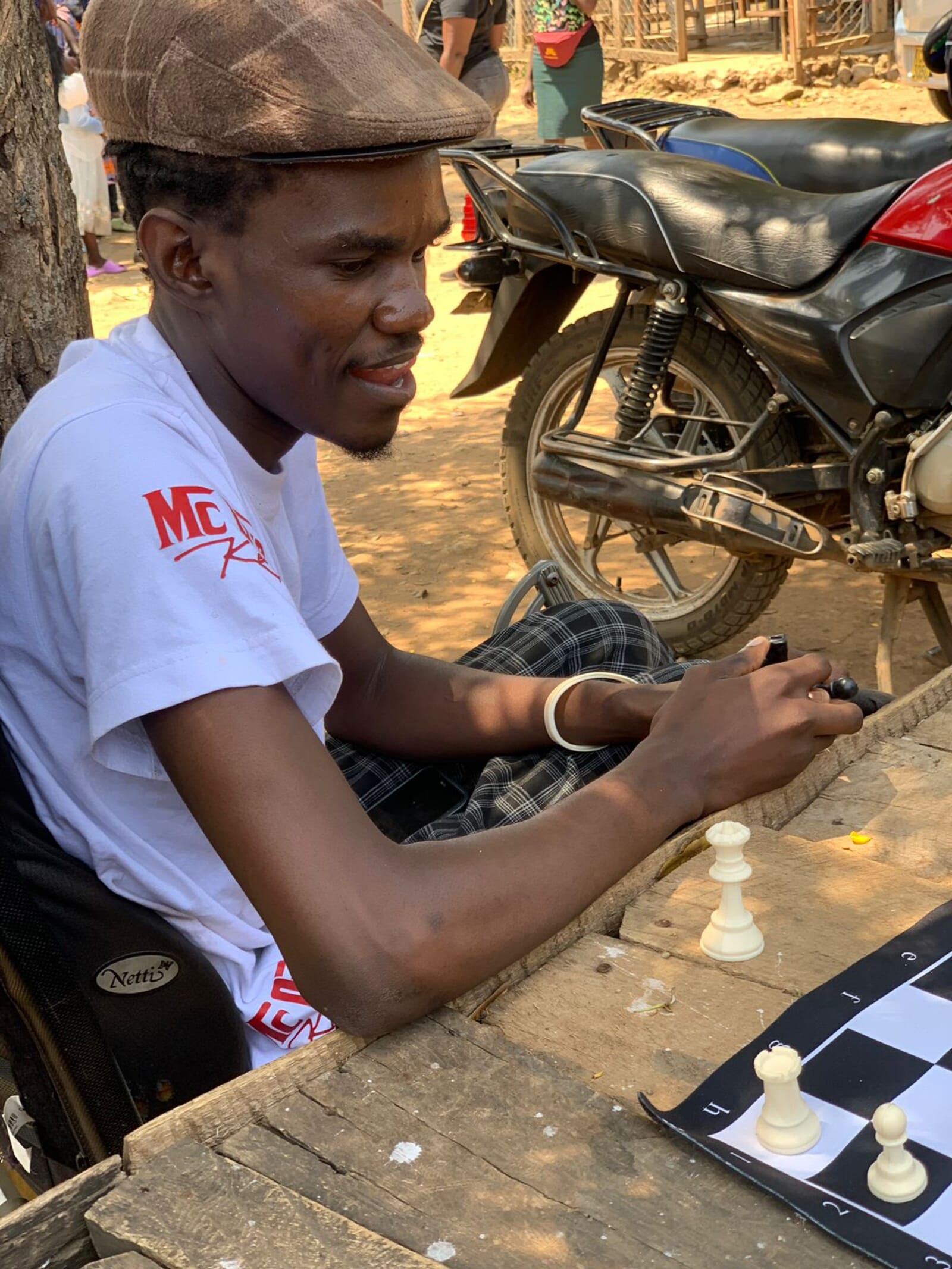 Chess player focused at an outdoor board